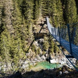 The suspension bridge leads high above the Averser Rhein