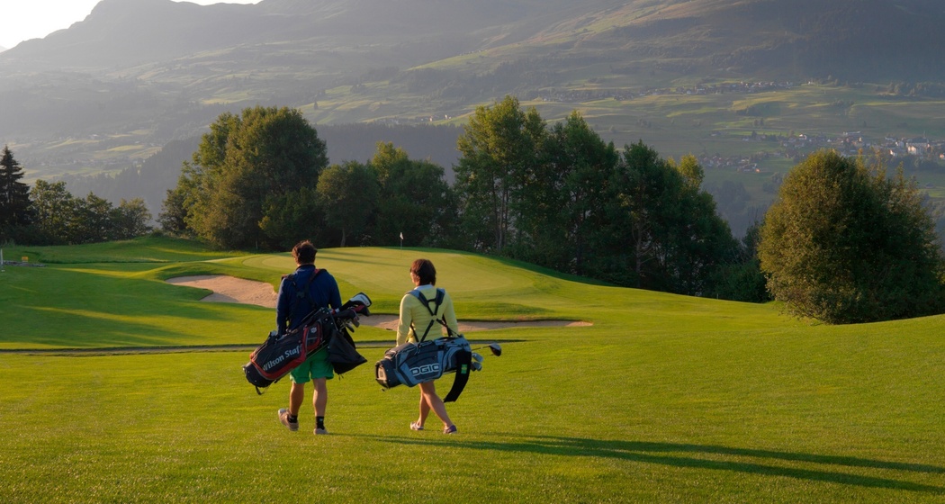 Das Foto zeigt zwei Golfer die auf dem Platz sind