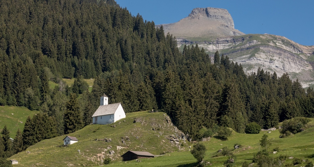 Das Foto zeigt die Kapelle St. Sievi mit einem Berg im Hintergrund