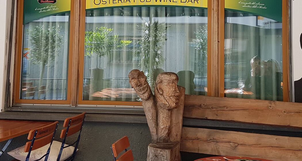 The facade of Bube's Pub with one of the artworks on its porch.