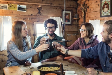 Eine Gruppe beim Essen in der Tegia Rasuz.