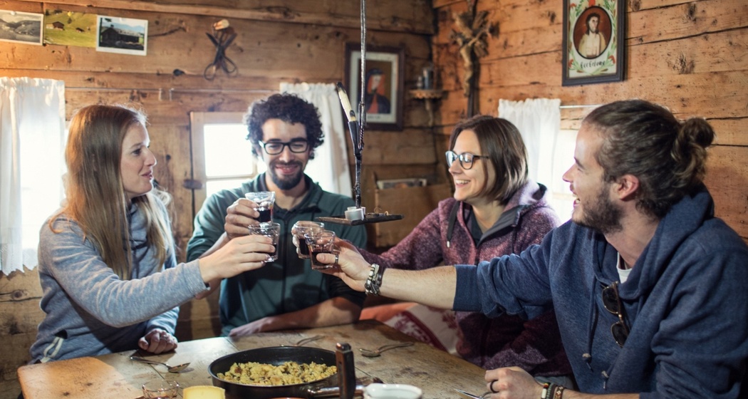 Eine Gruppe beim Essen in der Tegia Rasuz.