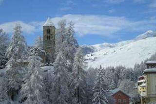 Ihre Aussicht mit freier Sicht auf die alte San Peder Kirche und das Skigebiet Motta Naluns